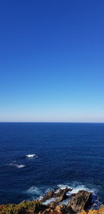 Scenic view of sea against clear blue sky