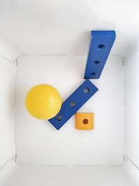 High angle view of toys on white wall