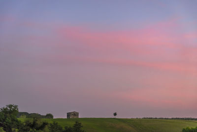 Scenic view of field against sky during sunset