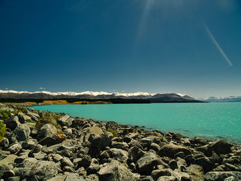 Scenic view of sea against blue sky