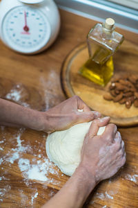 Cropped hands of person preparing food on table