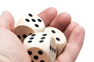 Cropped hand of person holding dice