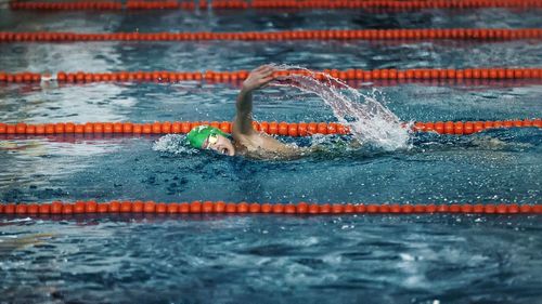 High angle view of boy swimming in pool