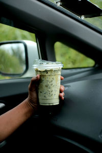 Cropped hand of person washing car