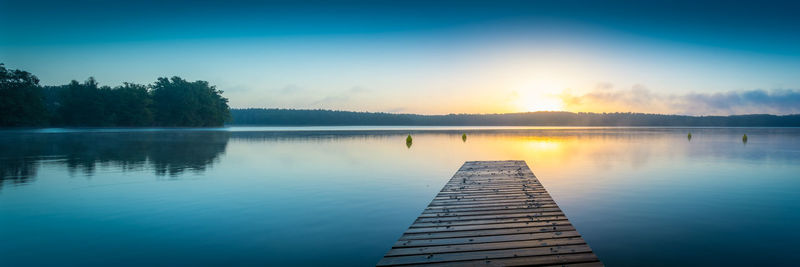 Pier over lake against sky