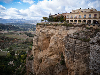 View of rock formation against cloudy sky