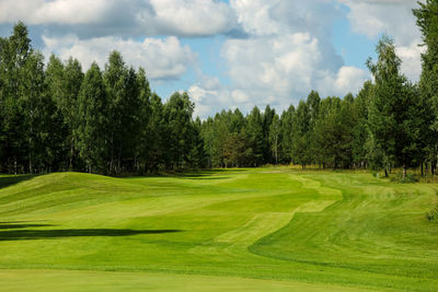 Panoramic view of golf course against sky