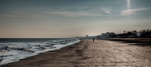 Scenic view of beach against sky during sunset