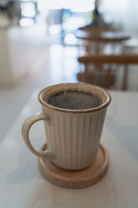 Close-up of coffee cup on table