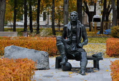 Statue in park during autumn