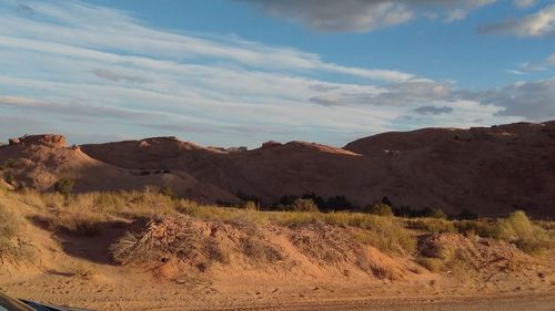 View of desert against cloudy sky