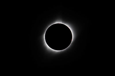 Low angle view of silhouette moon against sky at night