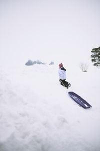 Person covering face covered in snow