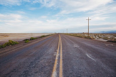 Road by landscape against sky