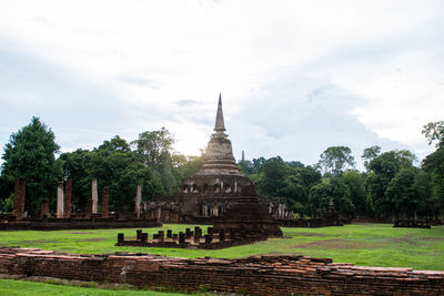 View of temple building against cloudy sky