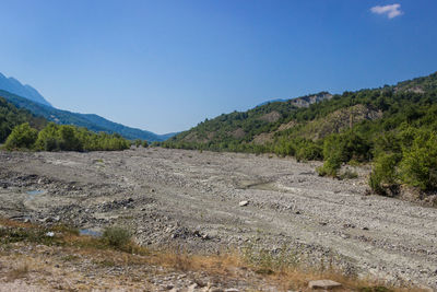 Scenic view of mountains against clear blue sky