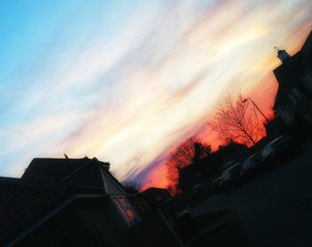 Low angle view of silhouette buildings against sky