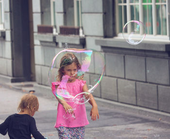 Girl playing with bubbles
