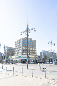 Buildings in city against clear sky