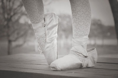 Low section of ballerina dancing on table