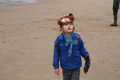 Full length of boy standing on beach