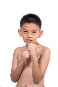 Close-up portrait of shirtless boy over white background