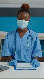 Female nurse wearing mask in clinic