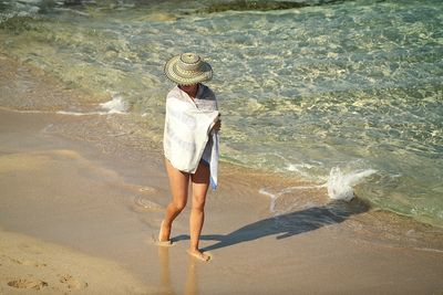 Full length of woman standing on beach