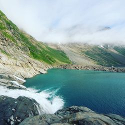 Scenic view of sea and mountains against sky