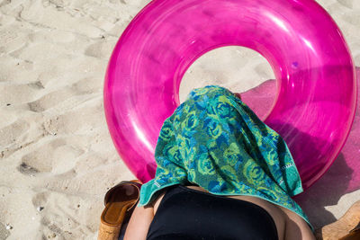 Low section of woman with pink umbrella