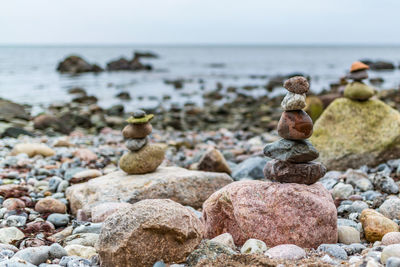 Close-up of pebbles on beach against sky