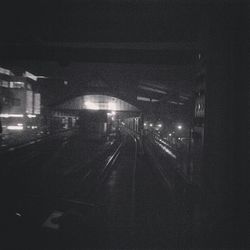 Illuminated tunnel at night