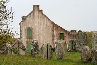 Old building on field against clear sky