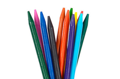 Close-up of multi colored pencils against white background