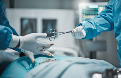 Midsection of doctor examining patient at clinic