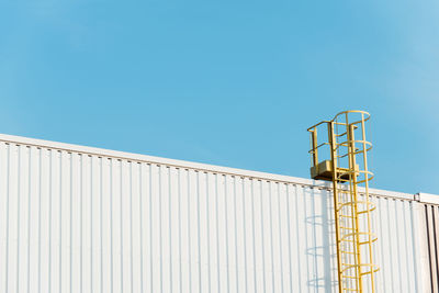 Low angle view of building against clear blue sky