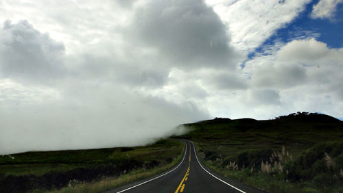 Country road against sky