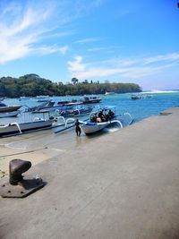 Boats moored on sea against sky