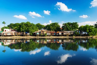 Reflection of trees and buildings in lake