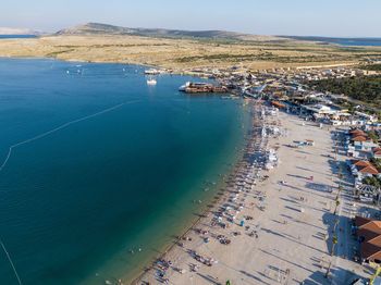 High angle view of sea against sky in city