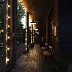 Illuminated street amidst buildings at night