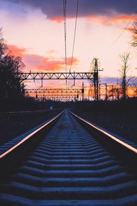 Railroad tracks against sky during sunset