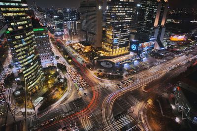 High angle view of illuminated city buildings at night