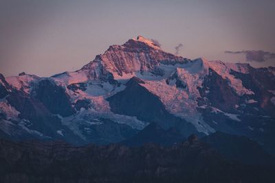 Sunlight falling on rock against sky