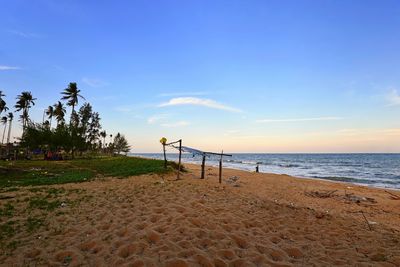 Scenic view of beach against blue sky