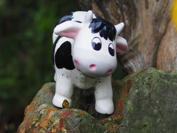 Close-up of cow toy on rock