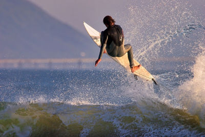 Full length of man jumping on sea