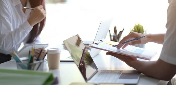 Midsection of woman working on table