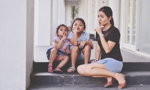 Full length of mother and her daughters