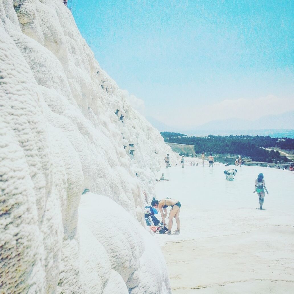 PANORAMIC VIEW OF PEOPLE ON MOUNTAIN AGAINST SKY